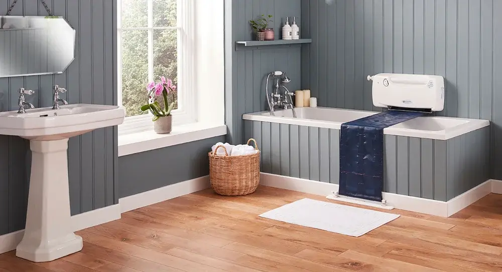Supplied photograph of the bath lift positioned across a bath in a panelled bathroom